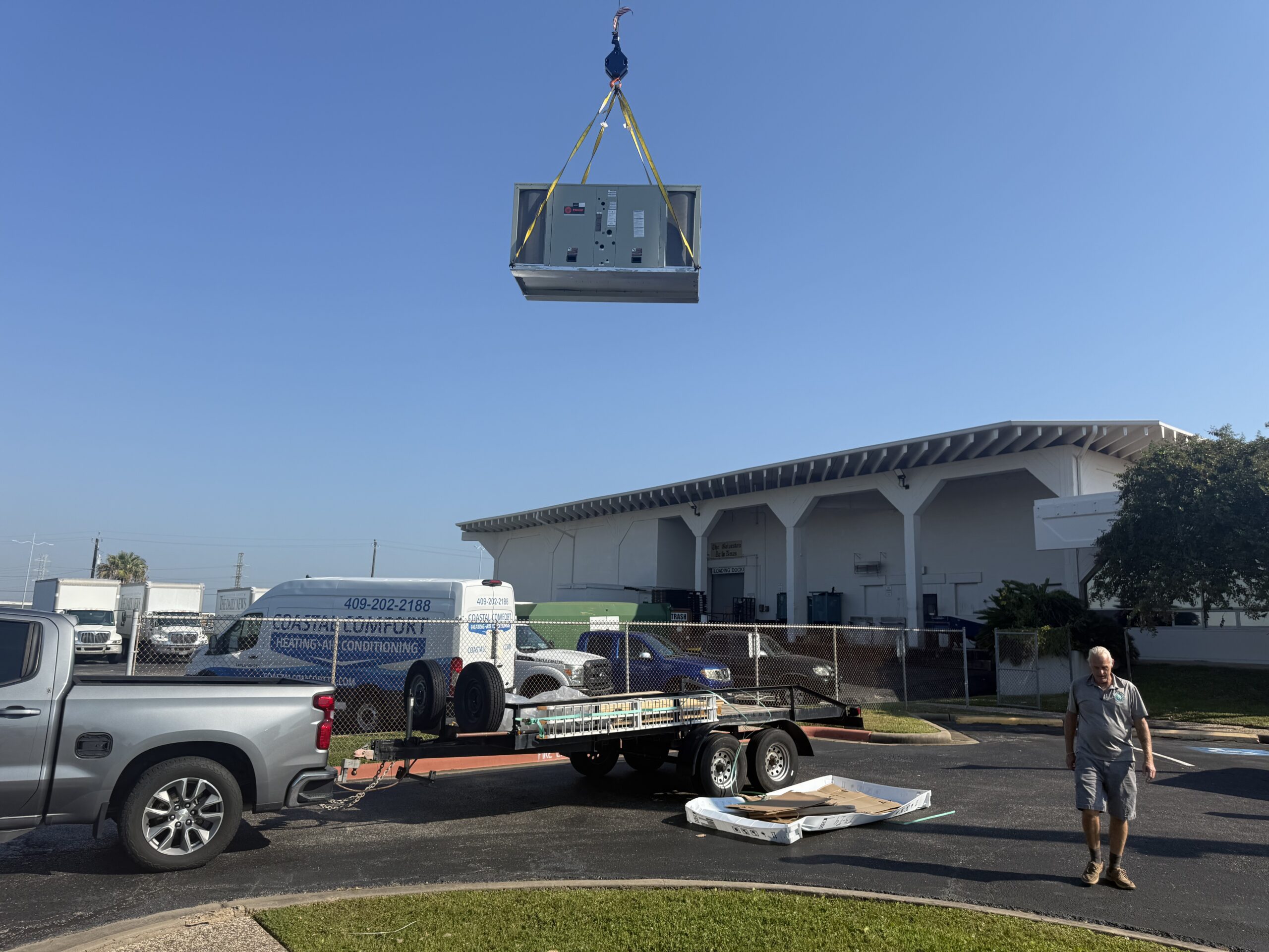 Crane installing rooftop package unit