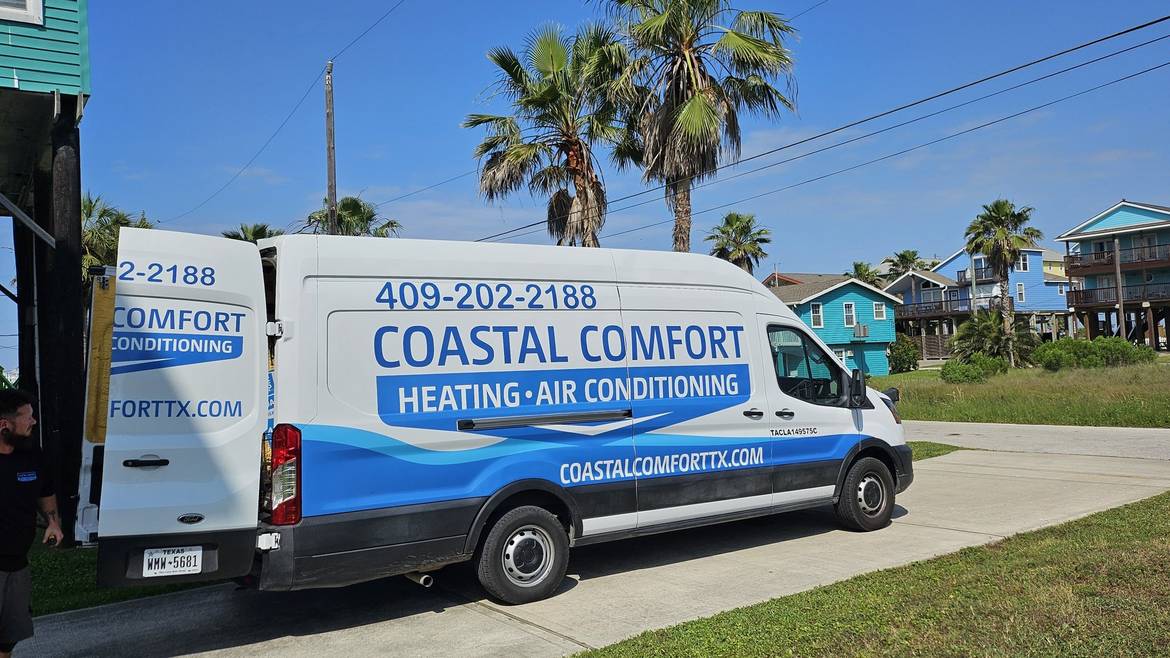 Coastal Comfort service van parked outside a Galveston beach home